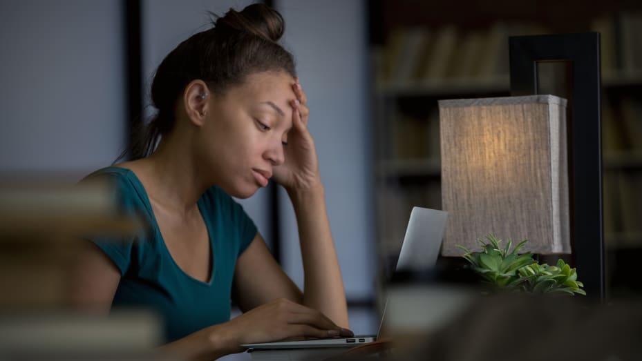 woman looks stressed at computer