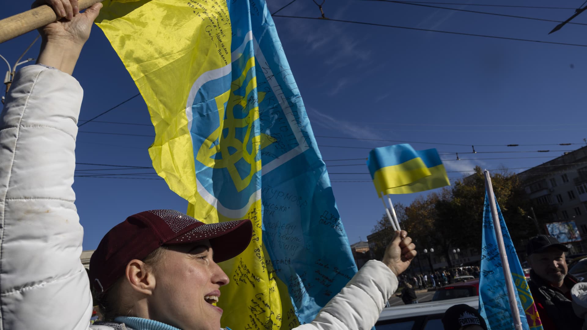 A woman celebrates Ukrainian troops' liberation of Kherson city on Monday, Nov. 14. President Volodymyr Zelenskyy made a surprise visit to the city after Russian forces fled to the other side of the Dnipro River.