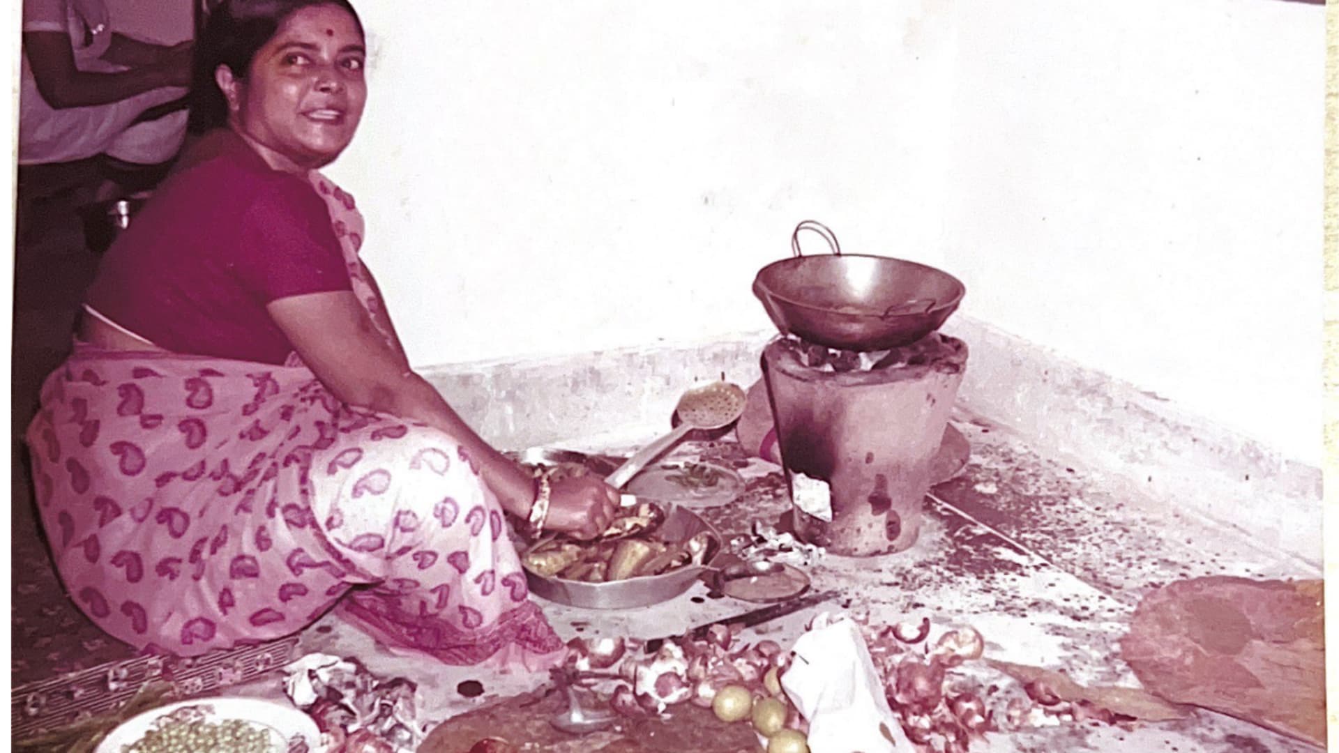 Arun Majumdar's mother cooking over a coal burning stove in India.