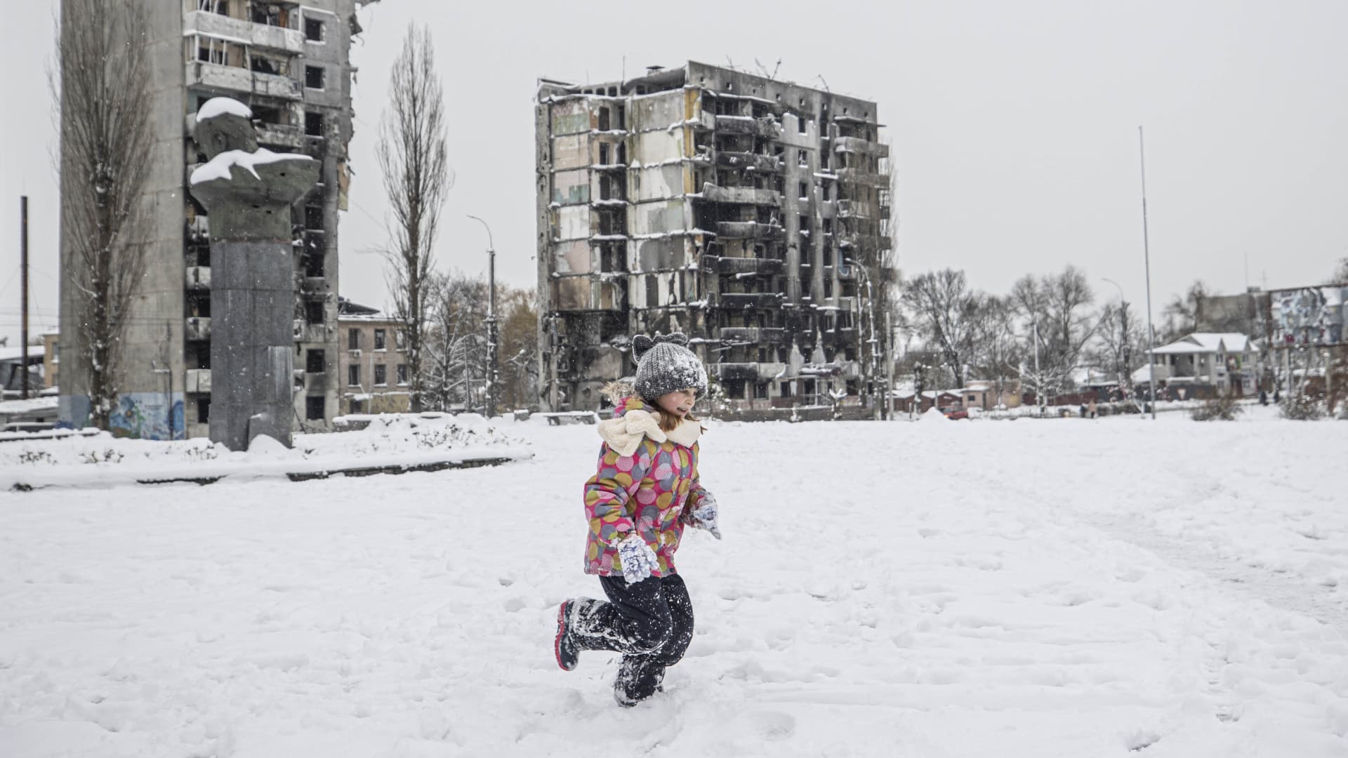 A child plays snowball as daily life continues in Borodyanka, following the withdrawal of Russian forces in Kyiv district, Ukraine on November 20, 2022.