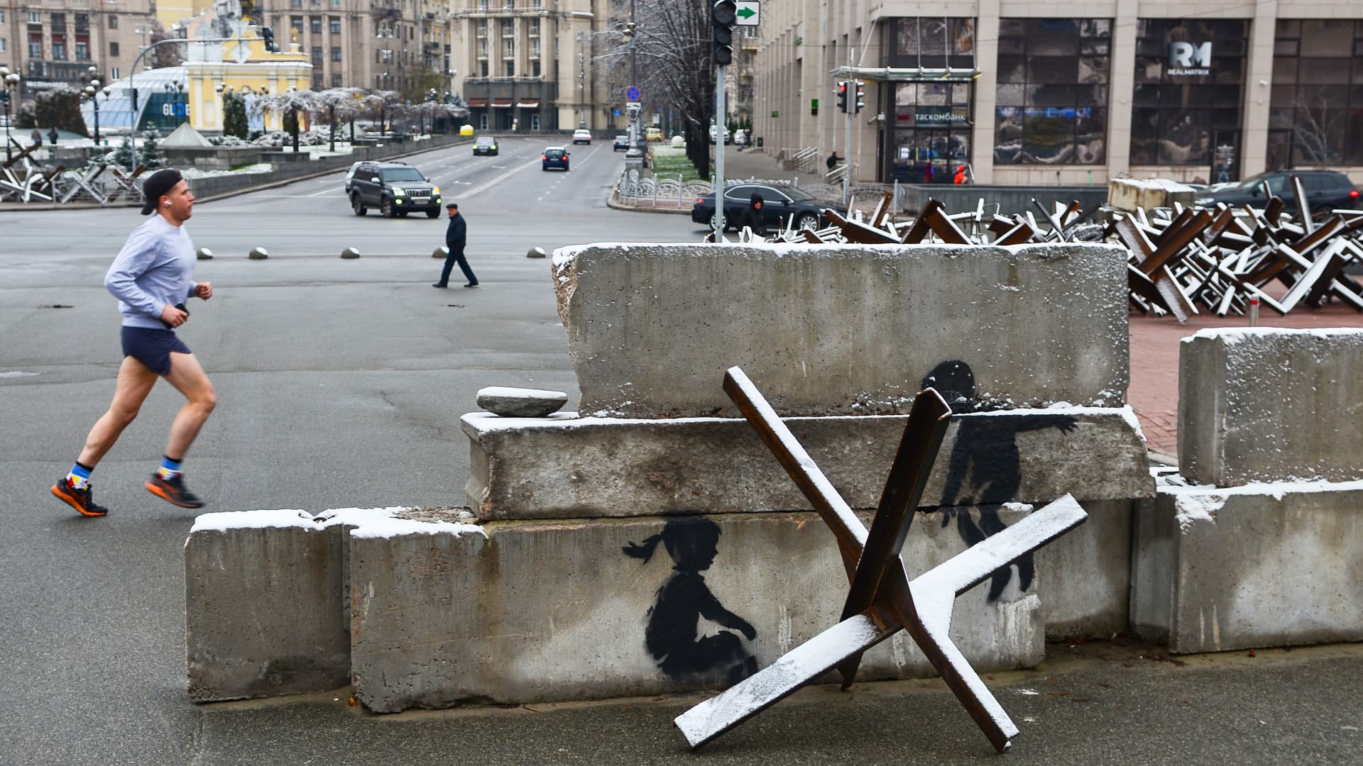 England-based street artist Banksy has transformed an anti-tank obstacle (Czech hedgehog) in Maidan Nezalezhnosti into a seesaw for a boy and a girl in his mural, Kyiv, capital of Ukraine. 