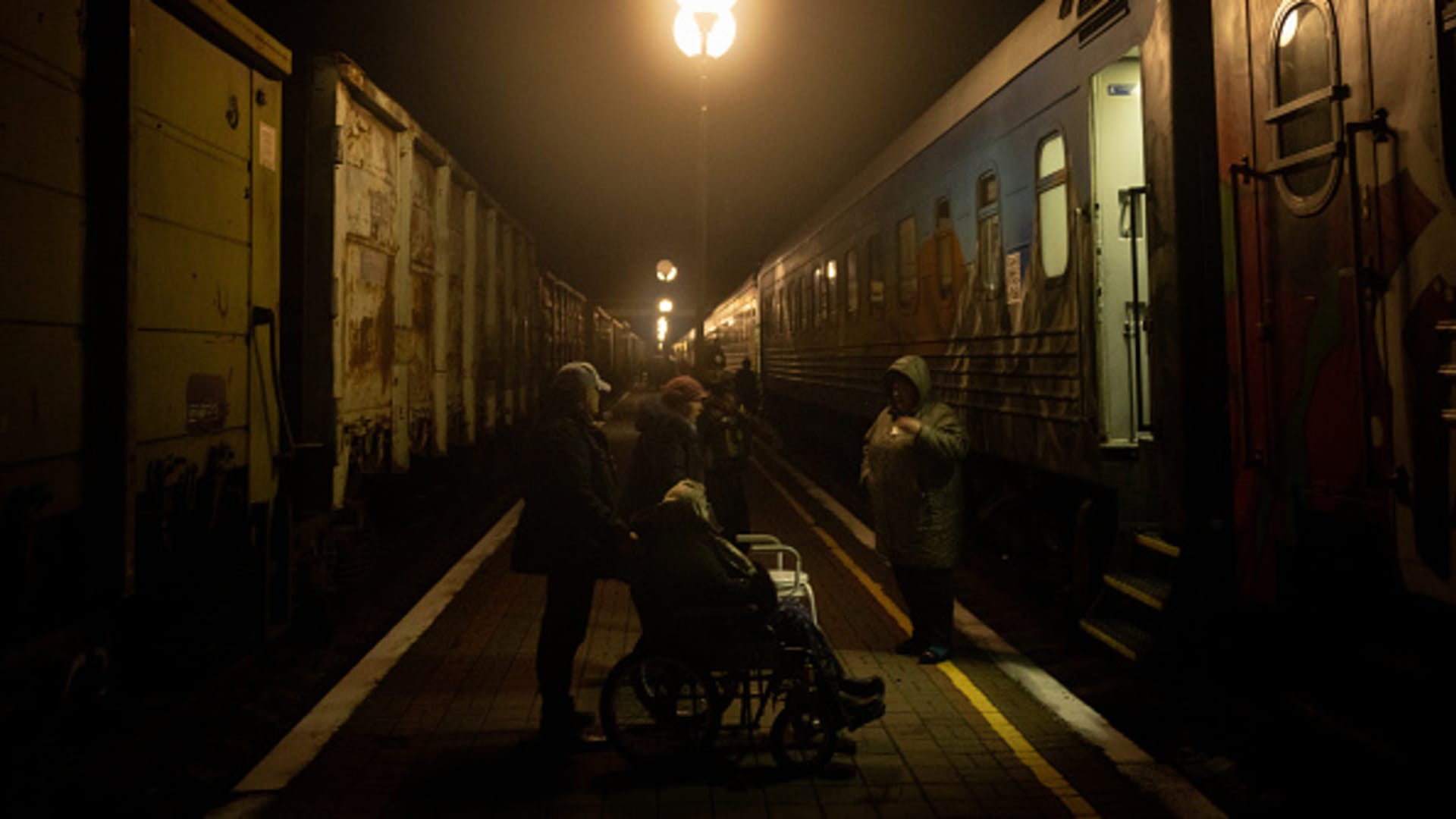 A woman in a wheelchair waits to be assisted to board an evacuation train on November 21, 2022 in Kherson, Ukraine. 