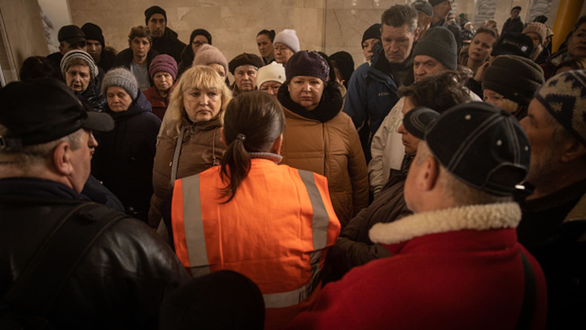 Residents talk to train station staff while waiting to be evacuated from Kherson on Nov. 21, 2022, in Kherson, Ukraine.