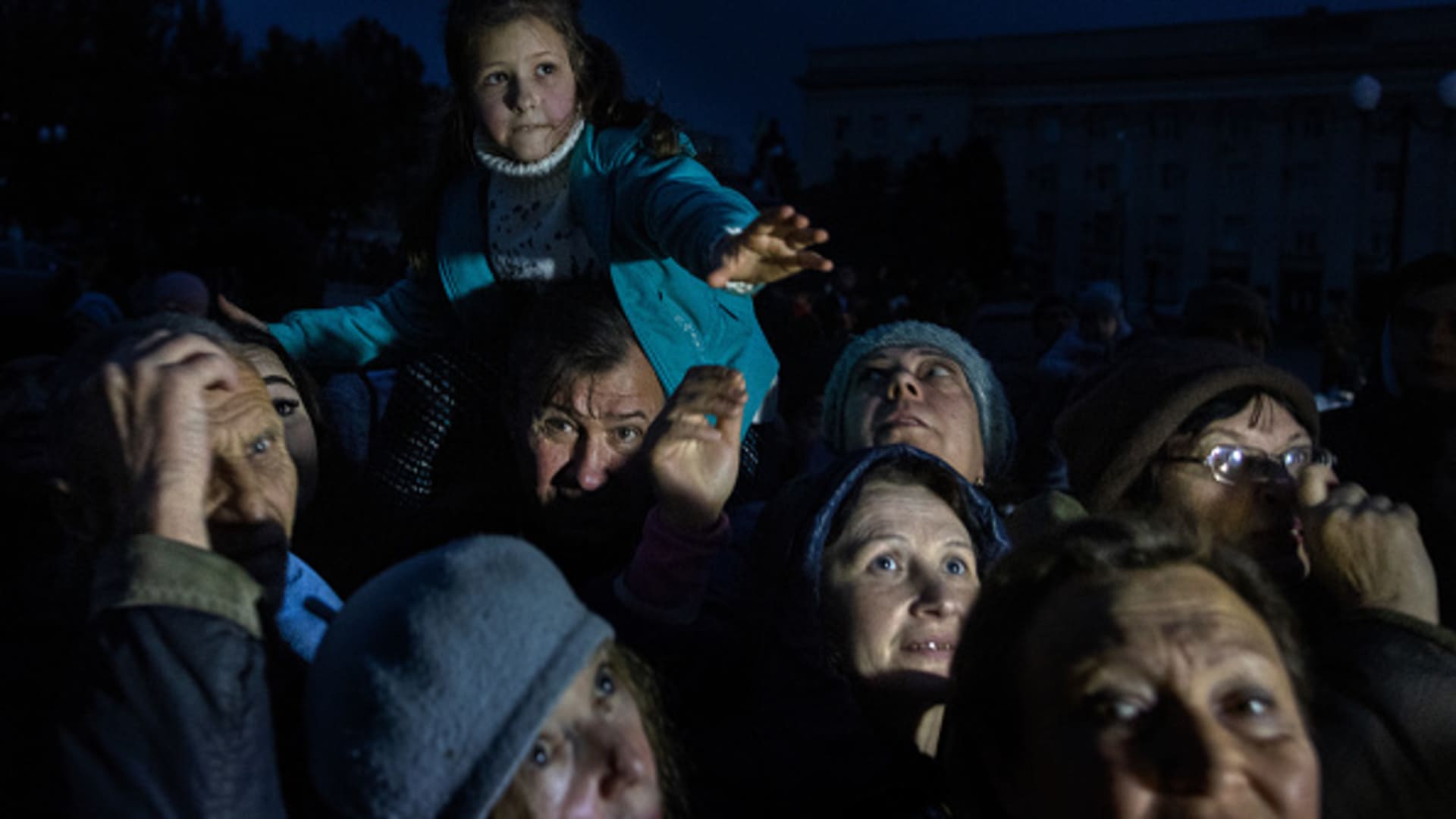 Kherson residents receive humanitarian aid waiting after dark as the city deals with no electricity or water since the Russian retreat on November 16, 2022 in Kherson, Ukraine.