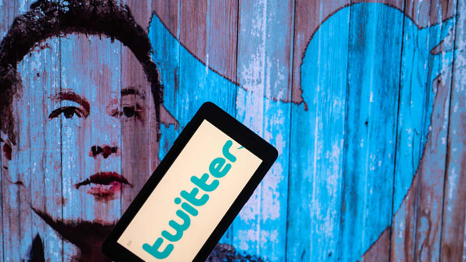 Elon Musk's Twitter account displayed on a mobile with Elon Musk in the background are seen in this illustration. In Brussels - Belgium on 19 November 2022.  (Photo illustration by Jonathan Raa/NurPhoto via Getty Images)