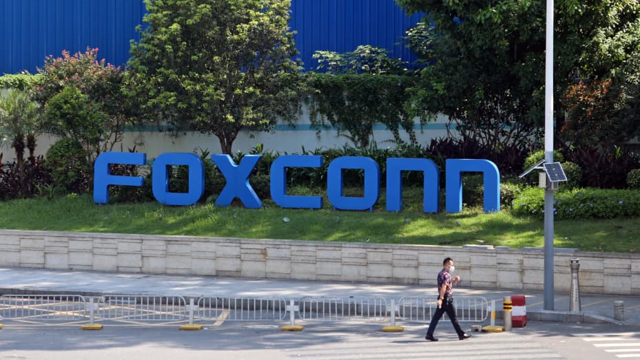 A man passes by a compound of the electronics manufacturer Foxconn in Shenzhen on Saturday, Sept. 3, 2022.