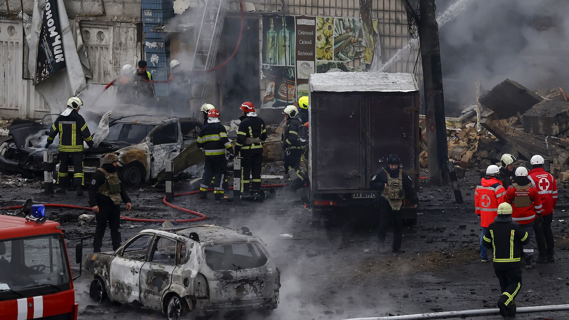 Fire and rescue workers attend a building hit by a missile in central Kyiv on November 23, 2022 in Kyiv, Ukraine.