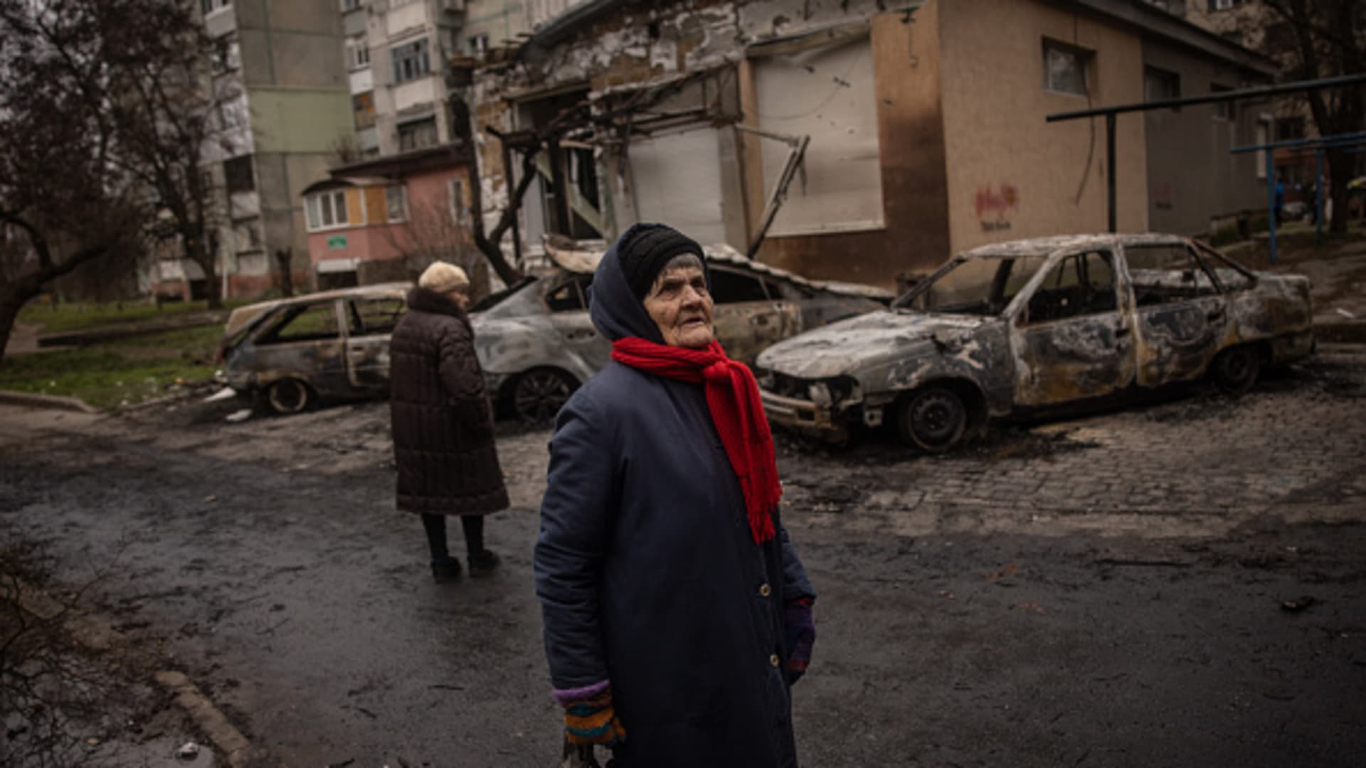 An elderly woman looks at damaged caused by overnight Russian shelling of a residential building on Dec. 1, 2022 in Kherson, Ukraine.