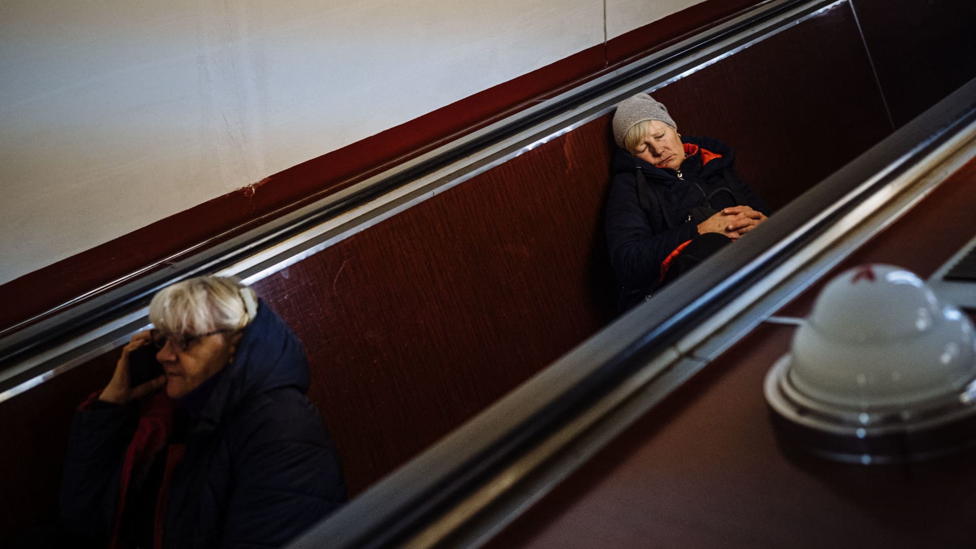 Civilians take shelter in a metro station during an airstrike alert in the centre of Kyiv on December 5, 2022, amid the Russian invasion of Ukraine.