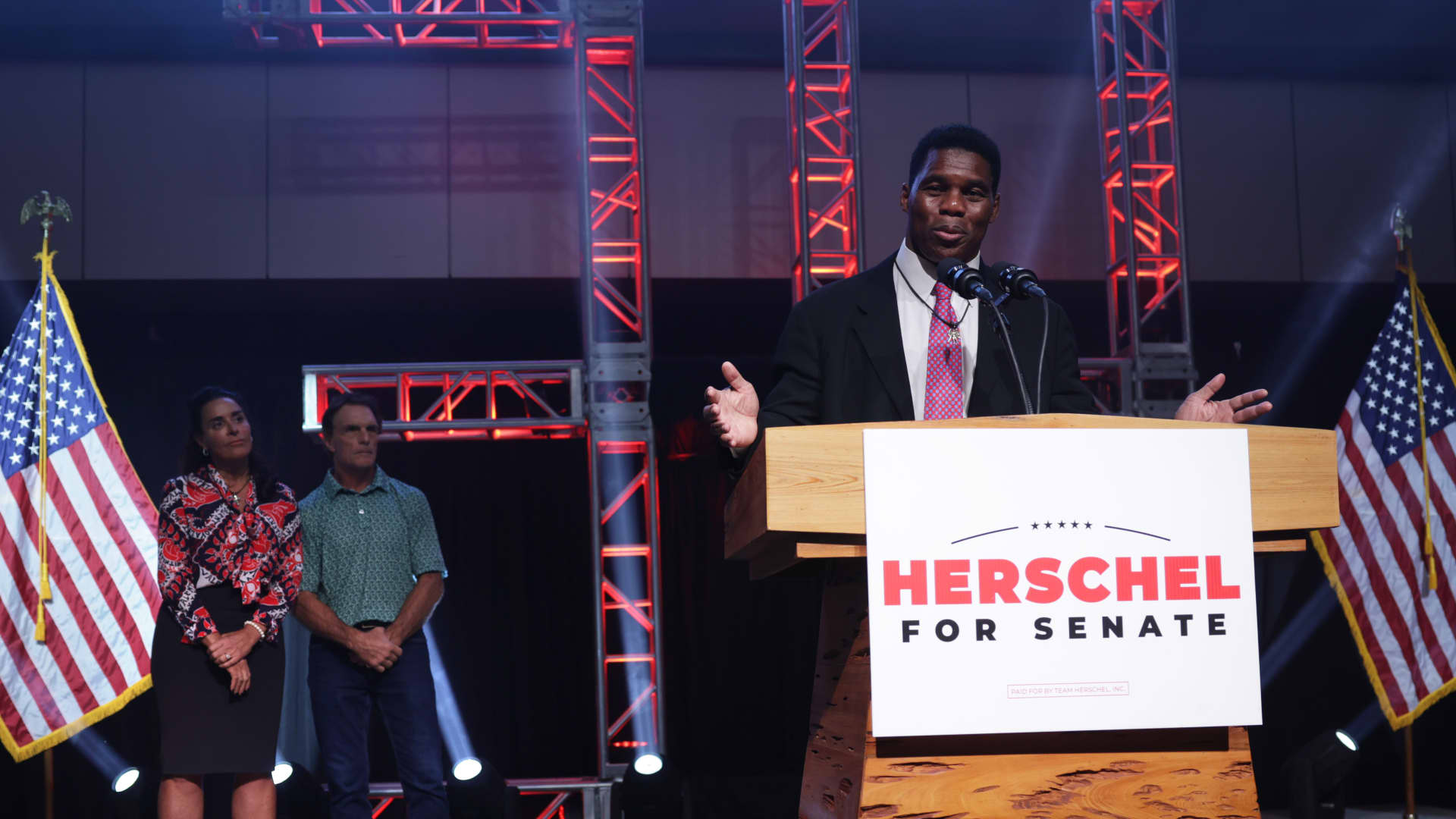 ATLANTA, GEORGIA - DECEMBER 06: Georgia Republican Senate candidate Herschel Walker delivers his concession speech as his wife Julie Blanchard and former football player Doug Flutie look on during an election night event at the College Football Hall of Fame on December 6, 2022 in Atlanta, Georgia. Tonight Walker lost his runoff election to incumbent Sen. Raphael Warnock (D-GA). (Photo by Alex Wong/Getty Images)