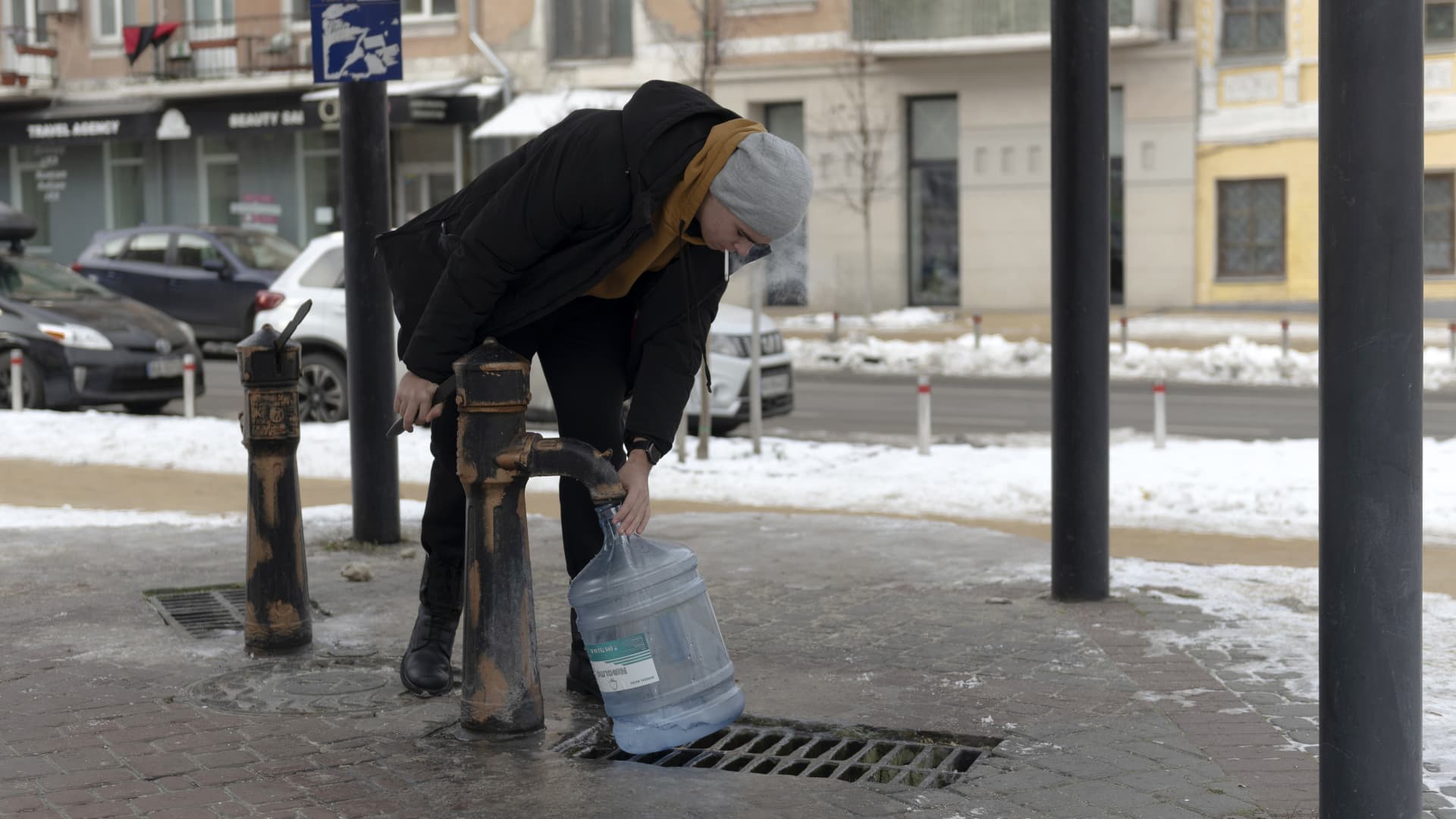 A resident collects water from a pump in Kyiv, Ukraine, on Tuesday, Dec. 6, 2022. Ukrainians have been no strangers to hardship over the past century, but their dogged resilience and solidarity in the face of Russian bombardment has been an enduring image of a war that started at the tail end of last winter. Photographer: Andrew Kravchenko/Bloomberg via Getty Images