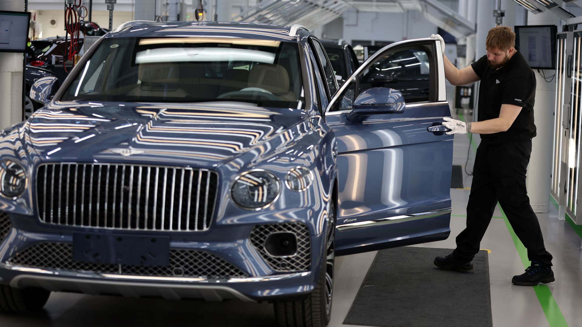 A staff member checks a Bentayga SUV on the Bentley production line at its factory in Crewe, England, on Dec. 7, 2022.