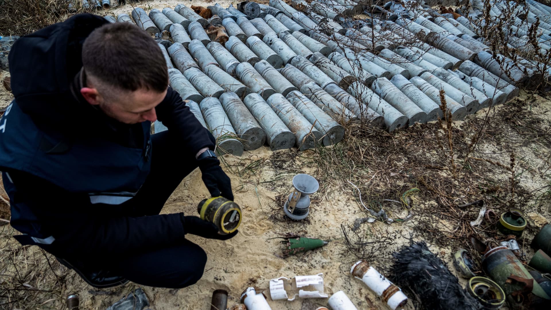 This aerial picture taken on December 7, 2022 shows experts and employees of the prosecutor's office examining collected remnants of shells and missiles used by the Russian army to attack the second largest Ukrainian city of Kharkiv, amid the Russian invasion of Ukraine. 