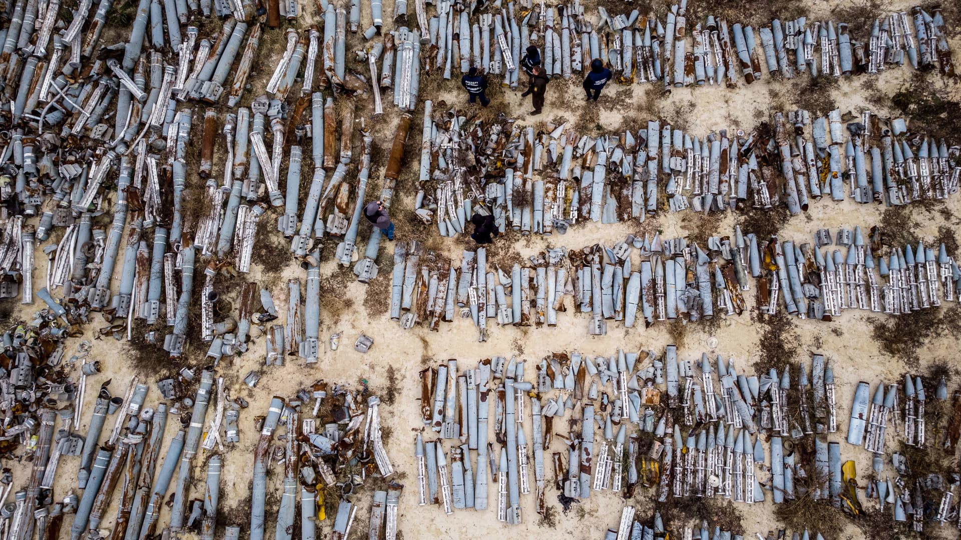 This aerial picture taken on December 7, 2022 shows experts and employees of the prosecutor's office examining collected remnants of shells and missiles used by the Russian army to attack the second largest Ukrainian city of Kharkiv, amid the Russian invasion of Ukraine. 