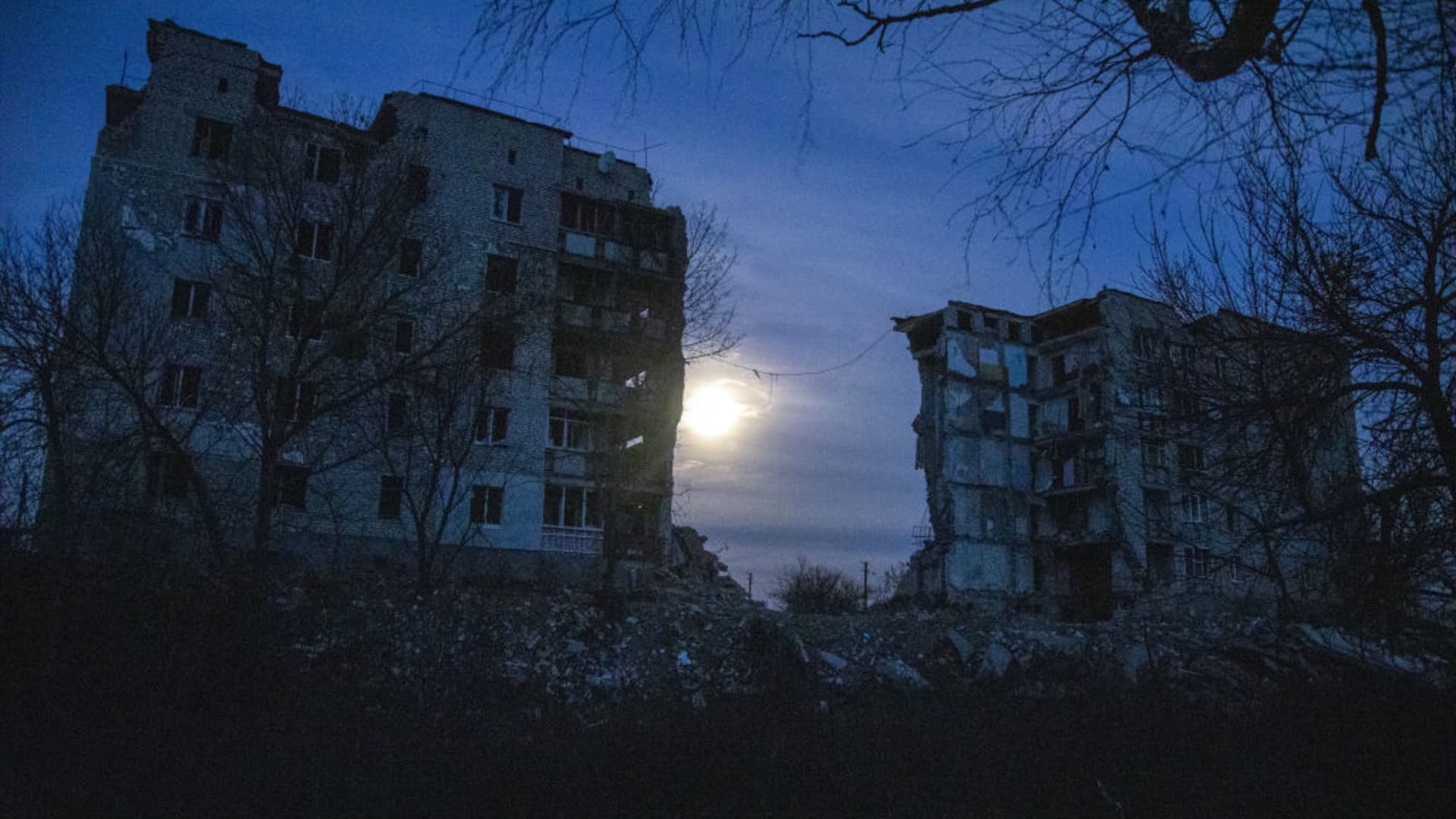 Night falls on a street where a destroyed building targeted during Russia-Ukraine war in Izyum City, Ukraine, December 07th, 2022.