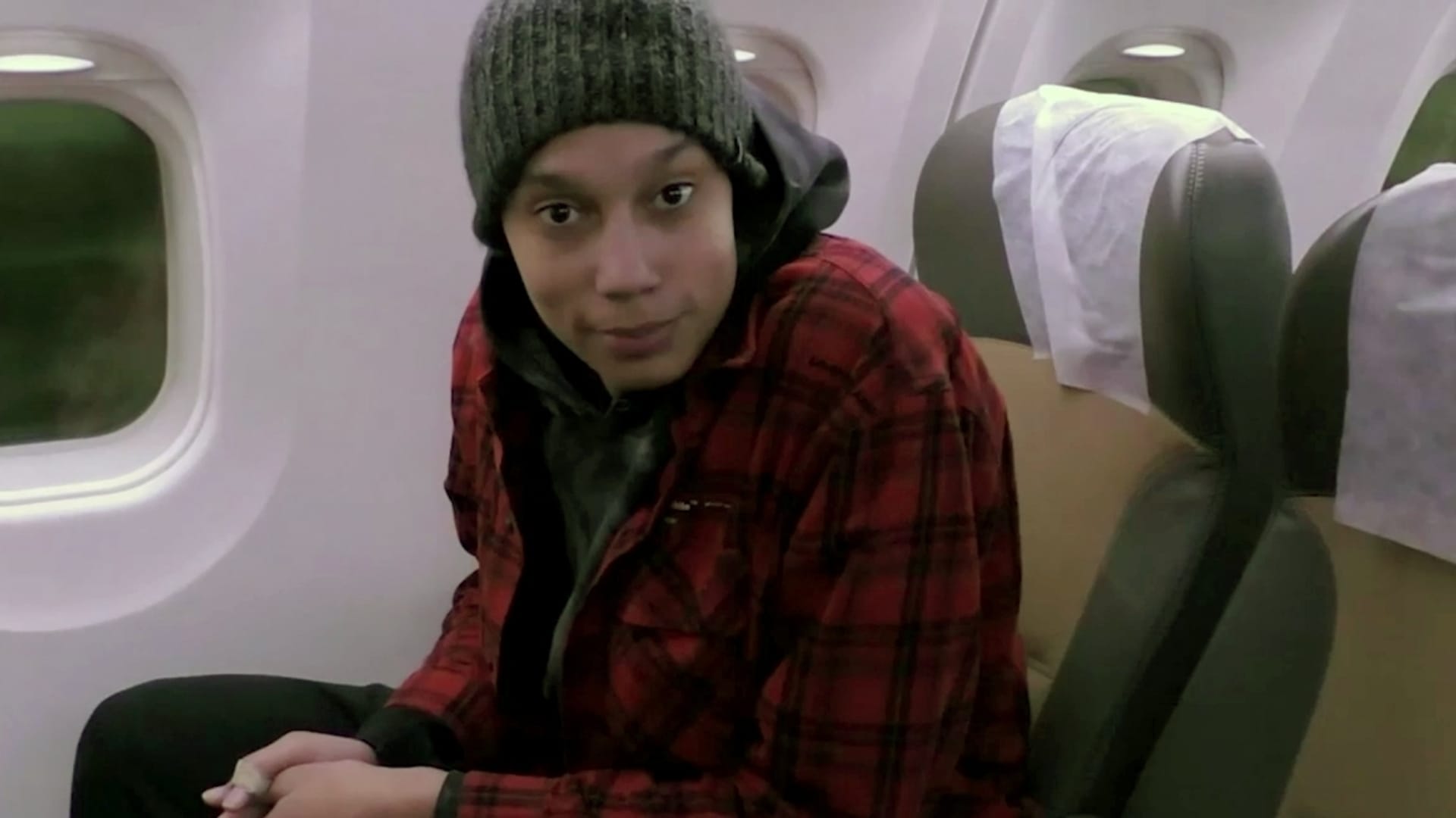 In this handout video grab released by the Russian Federal Security Service (FSB), US basketball player Brittney Griner is seen aboard a plane before her departure to the United States in Abu Dhabi, UAE. Griner, who was sentenced in Russia to nine years in jail and a fine of 1 million rubles ($16,576) in early August on charges of bringing drugs illegally into the country, was released on December 8 in prisoner exchange for Russian national Viktor Bout.