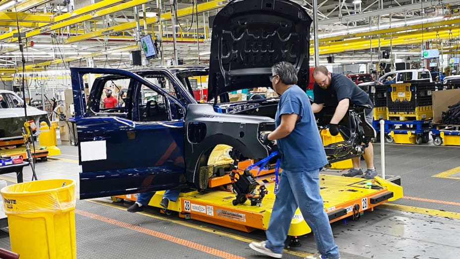 Ford workers produce the electric F-150 Lightning pickup on Dec. 13, 2022 at the automaker's Ford Rouge Electric Vehicle Center (REVC).