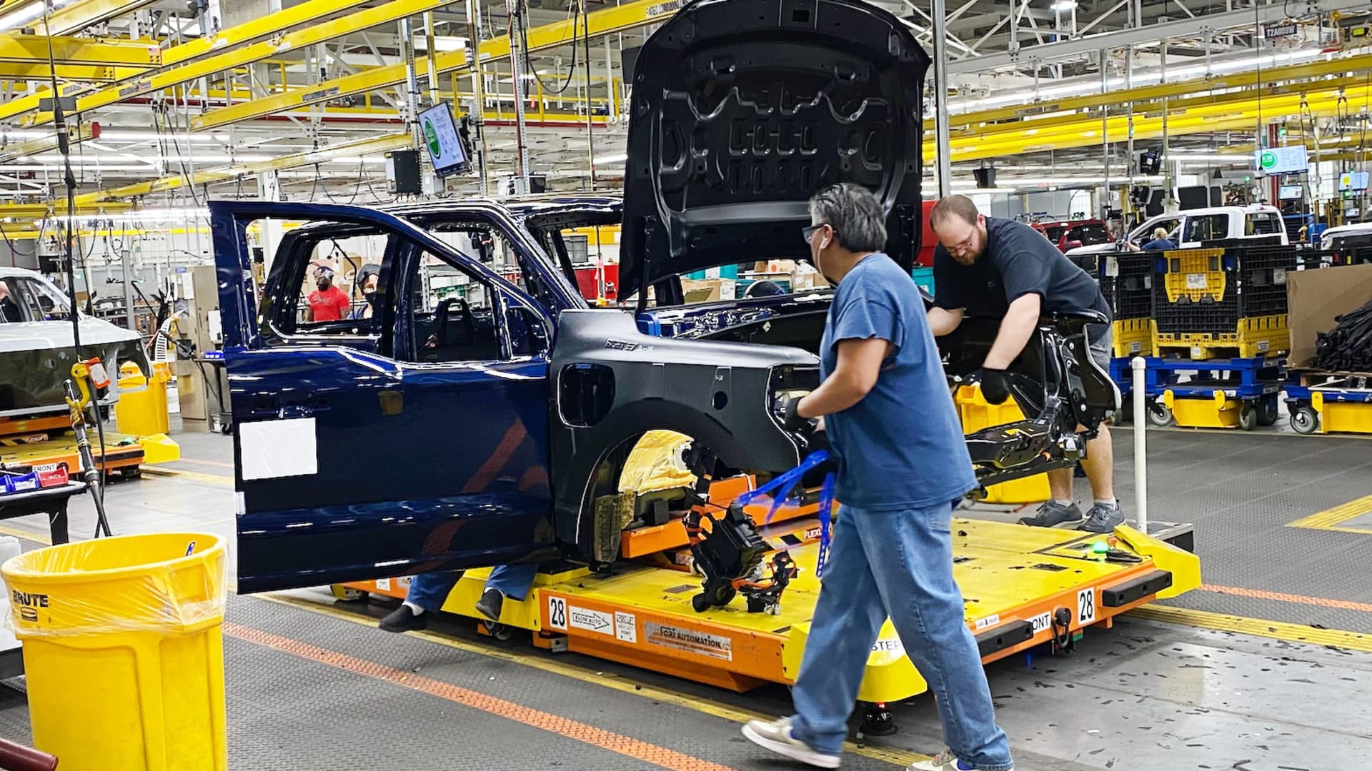 Ford workers produce the electric F-150 Lightning pickup on Dec. 13, 2022, at the automaker's Ford Rouge Electric Vehicle Center.