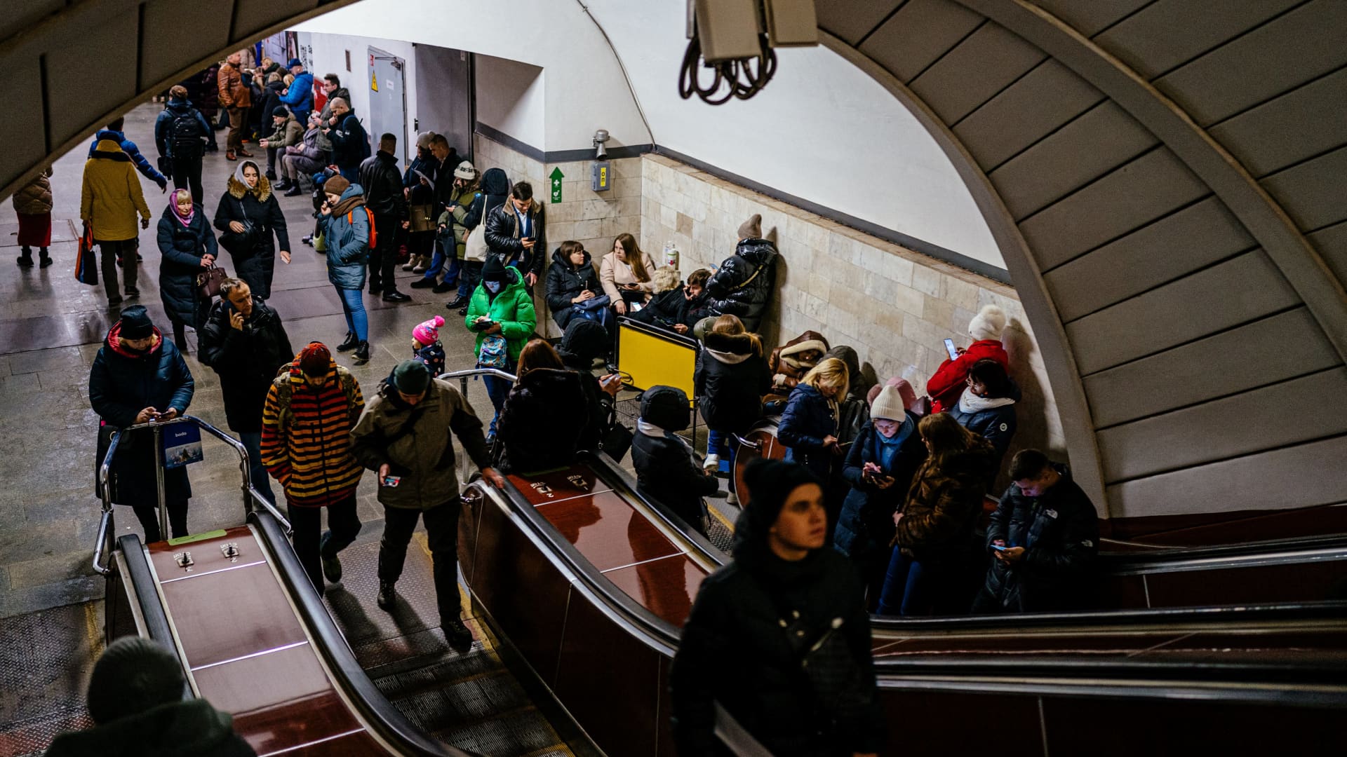 Civilians take shelter inside a metro station during air raid alert in the centre of Kyiv on December 13, 2022, amid the Russian invasion of Ukraine.