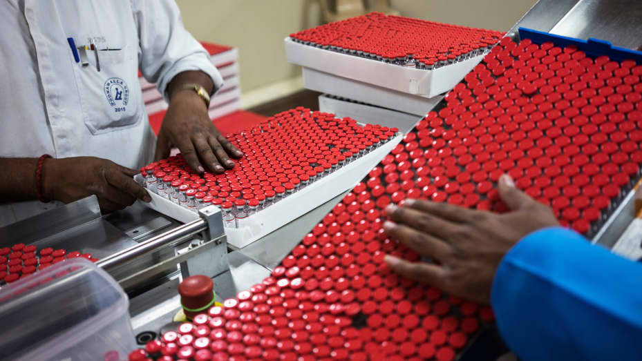 An employee, left, arranges labeled vaccine vials into a box as they exit a machine in the labeling unit at the Serum Institute of India Ltd. pharmaceutical plant in Pune, Maharashtra, India, on Monday, May 4, 2015. Serum, Asia's largest vaccine maker, will look at a possible merger with generic drugmaker Cipla Ltd. if the European venture between the two companies succeeds. Photographer: Sanjit Das/Bloomberg via Getty Images