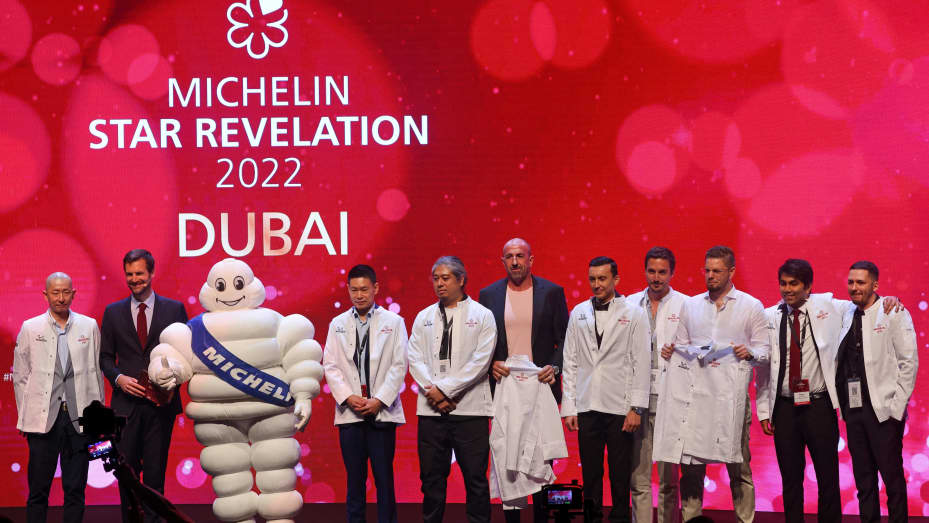 Chefs and owners pose for picture on the stage during a ceremony revealing the 2022 selection of the Michelin Guide Dubai, the first-ever edition in the United Arab Emirates, on June 21, 2022.