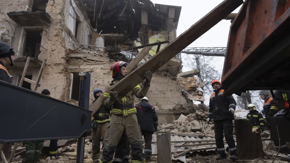 Ukrainian State Emergency Service firefighters work at the building which was destroyed by a Russian attack in Kryvyi Rih, Ukraine, Friday, Dec. 16, 2022. 