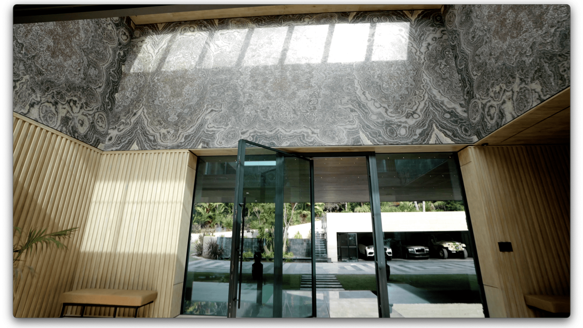 The upper half of the foyer's 25-foot walls are clad in onyx imported from Asia.