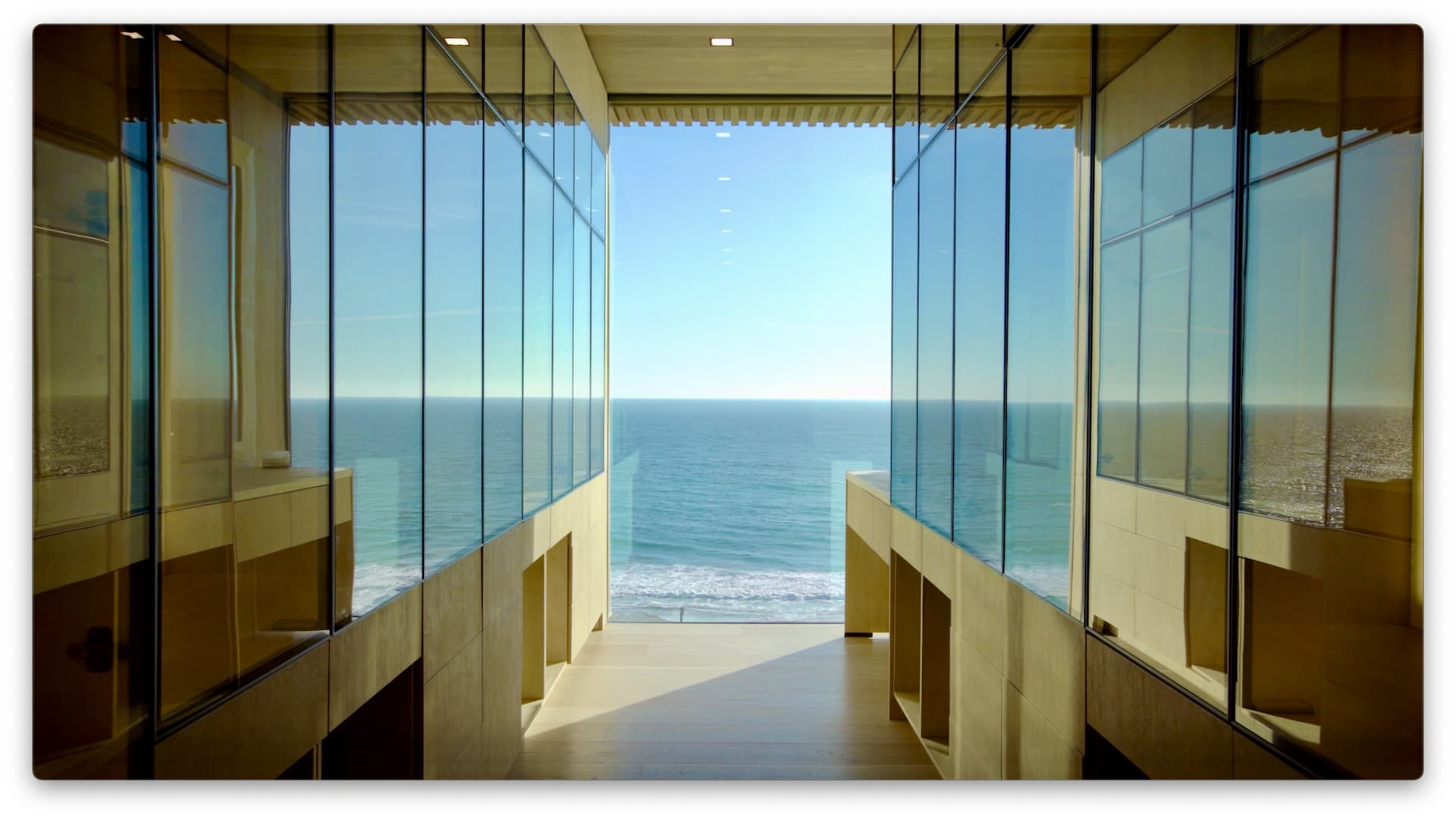 The primary suite's walk-in closets include a floor-to-ceiling window with impressive views of the ocean.