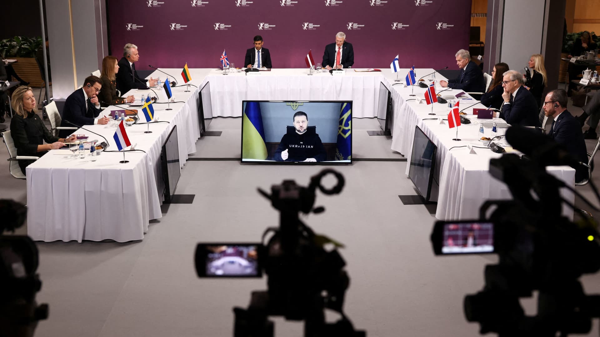 Ukrainian President Volodymyr Zelensky is displayed on a screen as he speaks via video link during a Joint Expeditionary Force (JEF) plenary session in Riga, Latvia December 19, 2022.