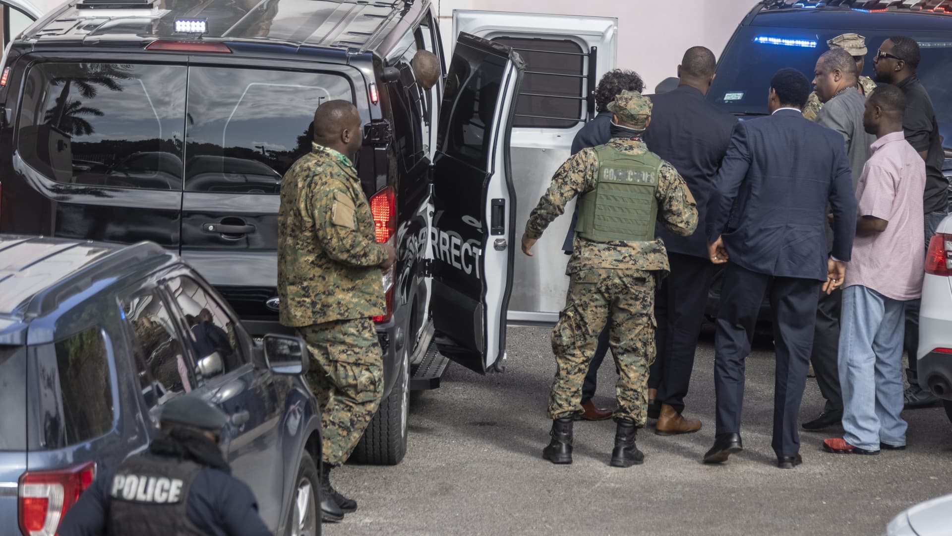 Sam Bankman-Fried, founder of FTX, is escorted inside of the Magistrate's Court in Nassau, Bahamas, on Monday, Dec. 19, 2022. 