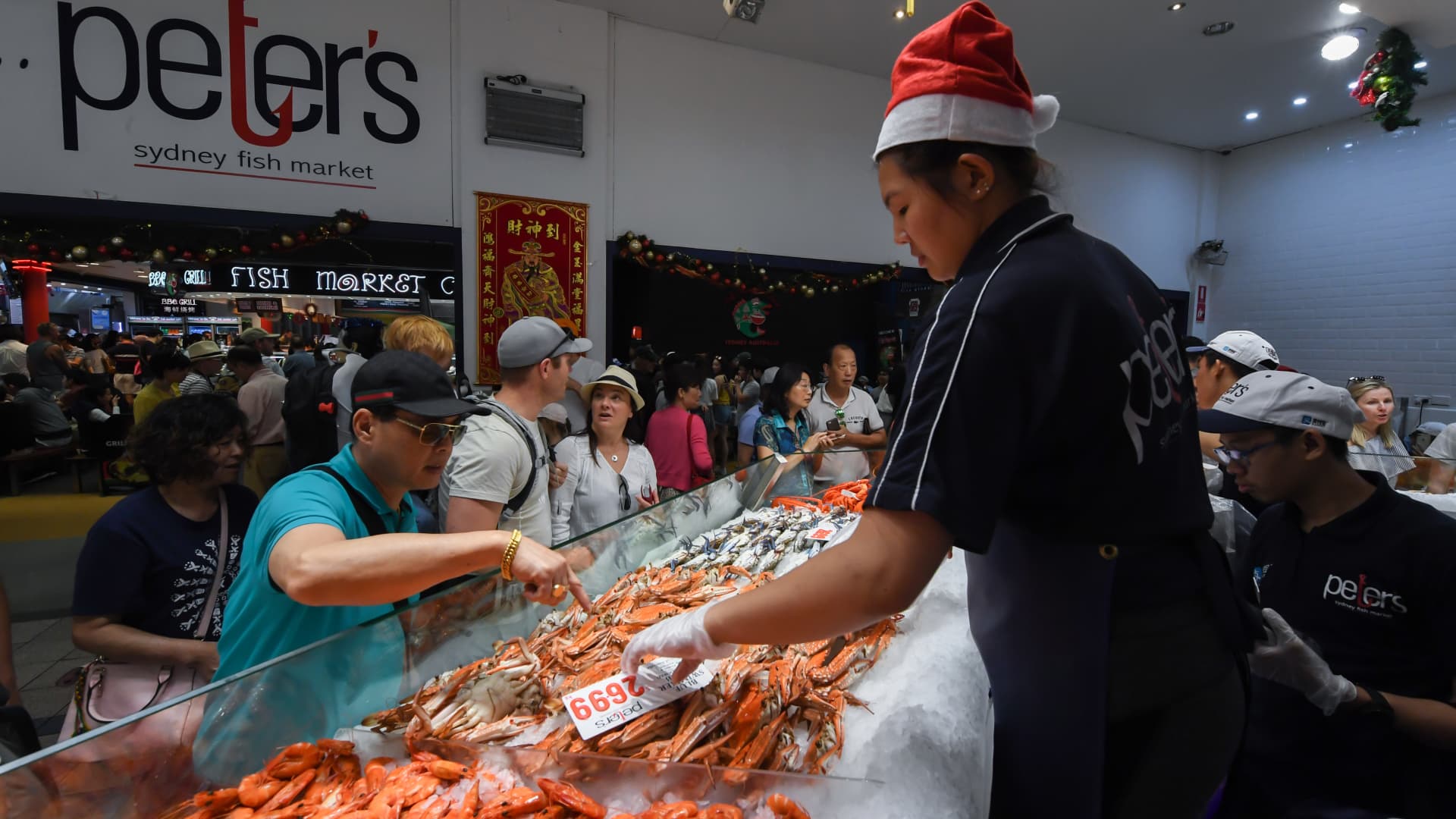 Crowds gather to buy prawns before Christmas at the Sydney Fish Market, which experiences its busiest week of the year before Christmas.