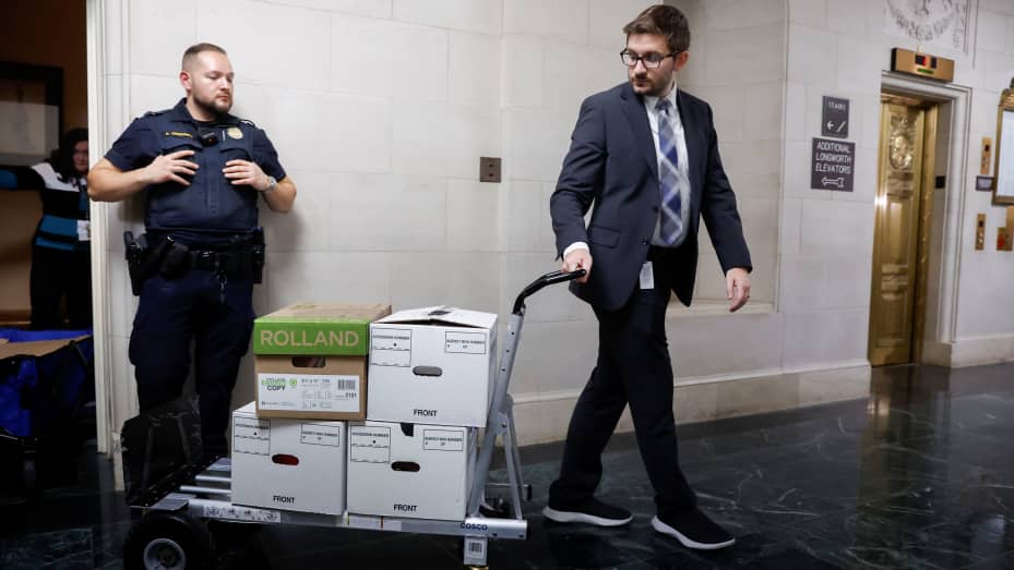 U.S. House Ways and Means Committee staff members transport boxes of documents after a committee meeting to discuss former President Donald Trump's tax returns on Capitol Hill in Washington, U.S., December 20, 2022. REUTERS/Jonathan Ernst