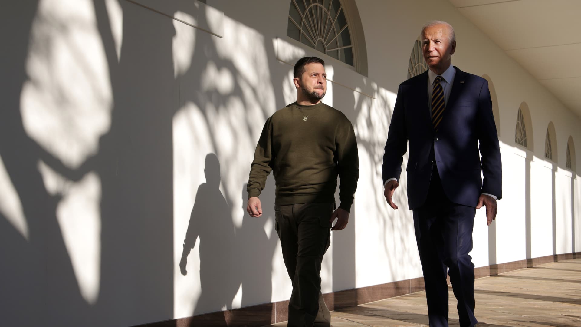 WASHINGTON, DC - DECEMBER 21: U.S. President Joe Biden (R) and President of Ukraine Volodymyr Zelensky walk down the Colonnade as they make their way to the Oval Office at the White House on December 21, 2022 in Washington, DC. Zelensky is meeting with President Biden on his first known trip outside of Ukraine since the Russian invasion began, and the two leaders are expected to discuss continuing military aid. Zelensky will reportedly address a joint meeting of Congress in the evening. (Photo by Alex Wong/Getty Images)