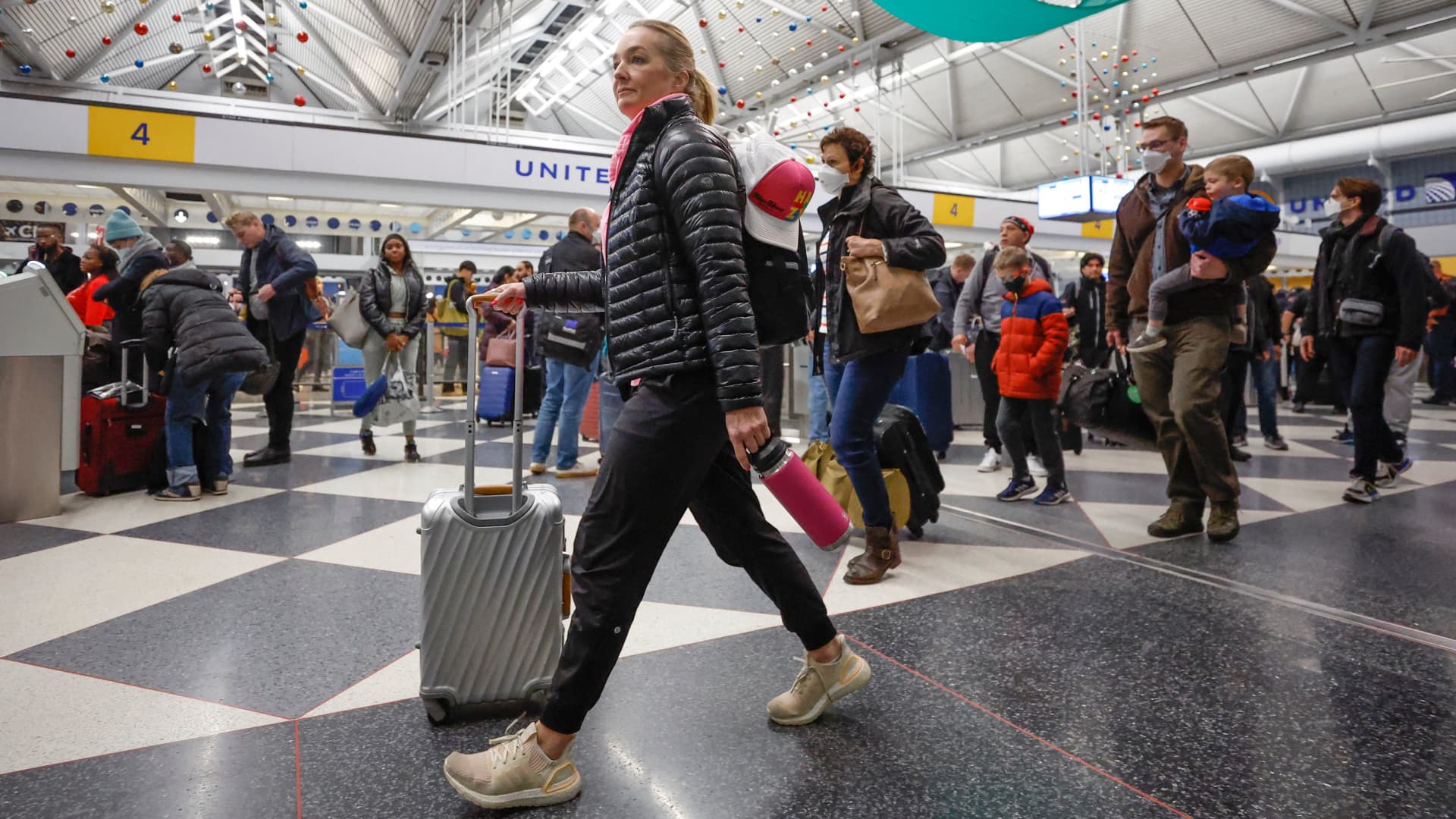 Travelers arrive for their flights at United Airlines Terminal 1 ahead of the Christmas Holiday at O'Hare International Airport on December 22, 2022, in Chicago.