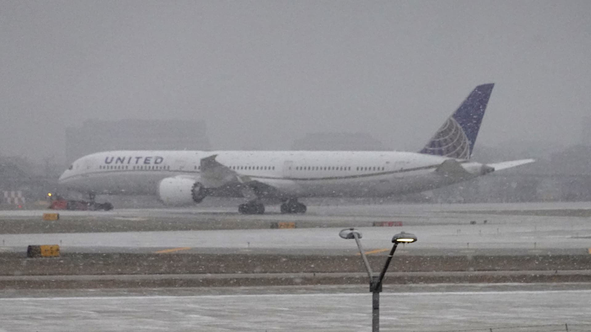 A jet taxis in snow at O'Hare International Airport on December 22, 2022 in Chicago, Illinois.