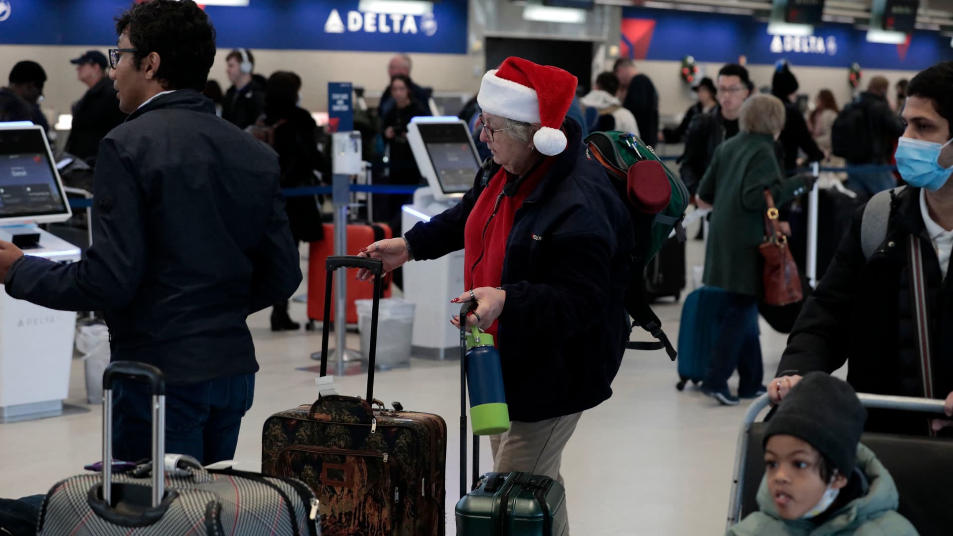 Passengers check in at the Delta counter at Detroit Metro Airport in Romulus, Michigan, on December 22, 2022. 
