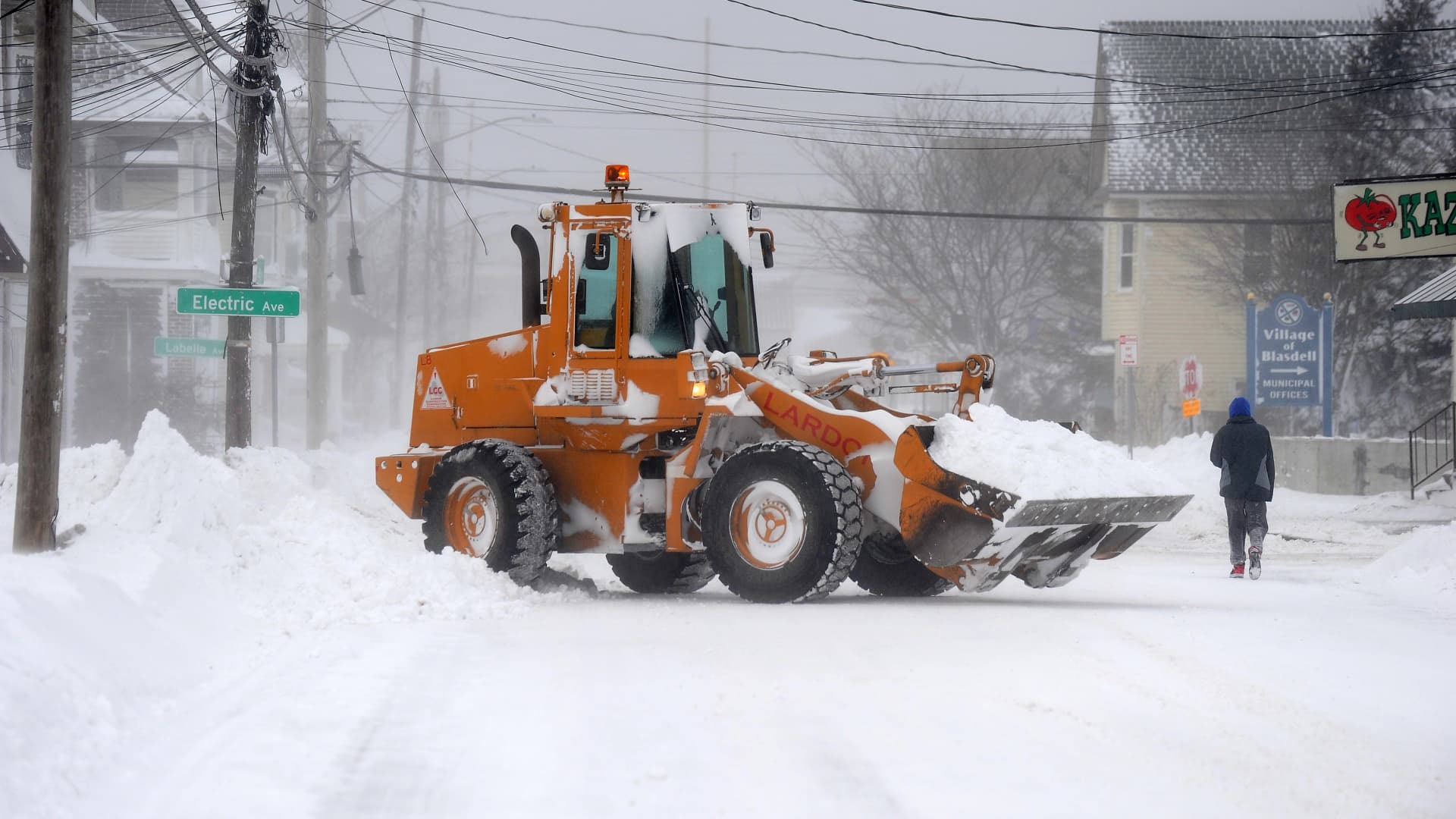 A loader clears roadways on December 24, 2022 in Hamburg, New York. The Buffalo suburb and surrounding area was hit hard by the winter storm Elliott with wind gusts over 70 miles per hour battering homes and businesses through out the holiday weekend. (Photo by John Normile/Getty Images)