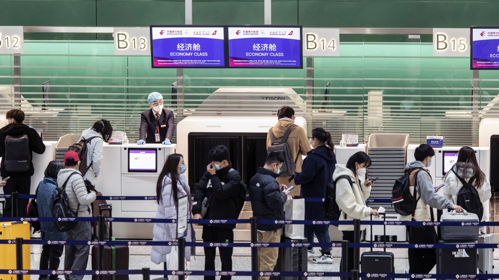 Travelers check in at Shanghai's Hongqiao International Airport in on Dec. 12, 2022, after China relaxed domestic travel restrictions.