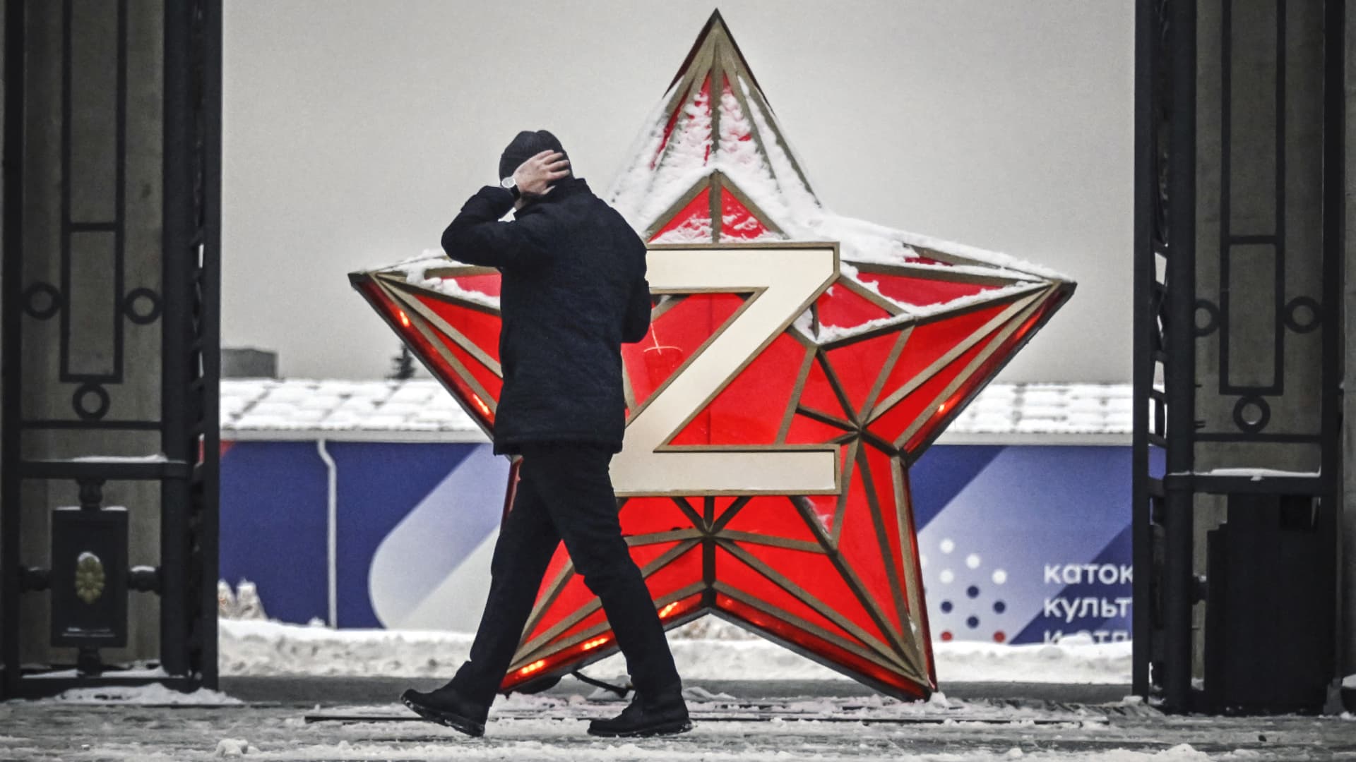 A person walks past a New Year decoration Kremlin Star, bearing a Z letter, a tactical insignia of Russian troops in Ukraine, at the Gorky Park in Moscow on December 29, 2022.