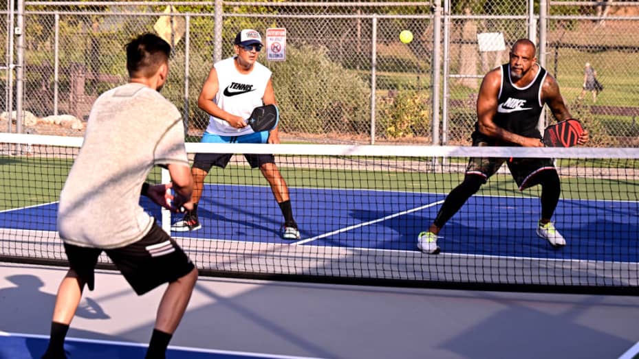 South Pasadena, CA - July 23: Pete Dinero, right, eyes a shot as his partner David Valera looks on as they play pickleball at the Arroyo Seco Racquet Club in South Pasadena on Saturday, July 23, 2022.
