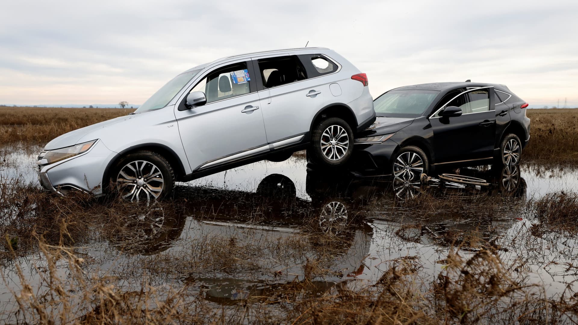 Cars are piled up next to a wheelchair submerged in the water after rainstorms caused flooding in Sacramento County, in Wilton, California, U.S. January 2, 2023.