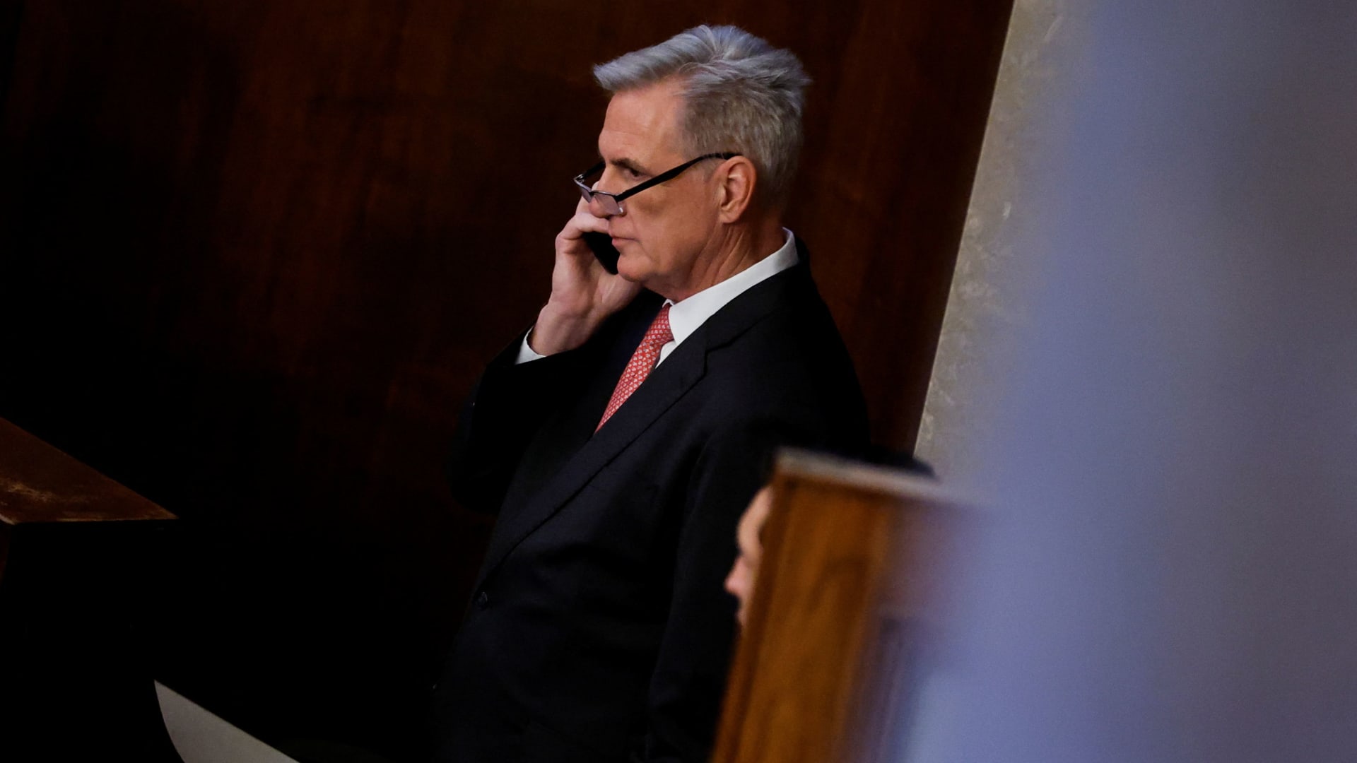 House Republican Leader Kevin McCarthy (R-CA) talks on a mobile phone inside the House Chamber during voting for a new Speaker on the third day of the 118th Congress at the U.S. Capitol in Washington, January 5, 2023.