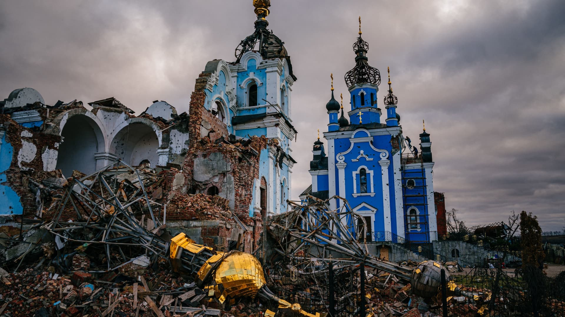 Construction workers climb onto the roof of a destroyed church in the village of Bohorodychne, Donetsk region on January 4, 2023, amid the Russian invasion of Ukraine.