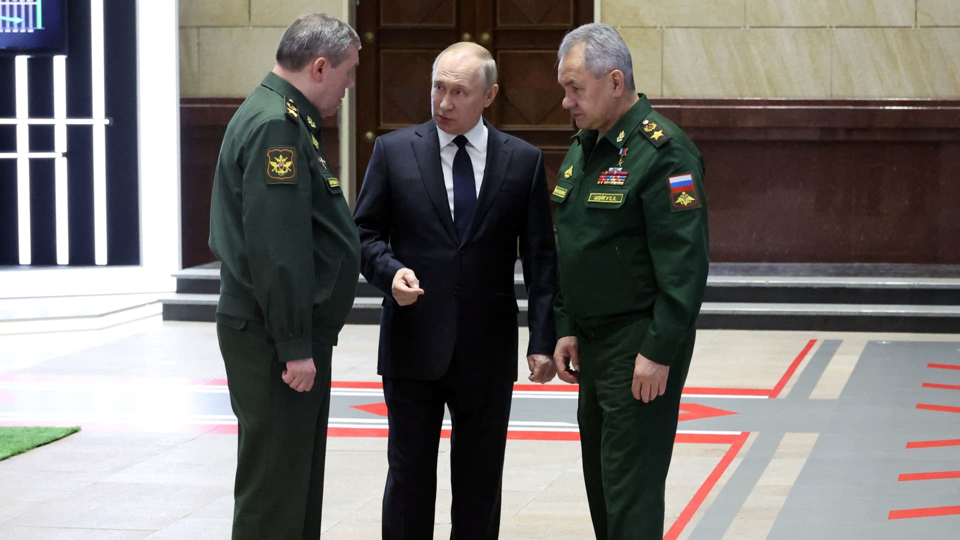 Russian President Vladimir Putin (C) speaks with Defence Minister Sergei Shoigu (R) and Chief of the Gen. Valery Gerasimov (L) after a meeting of the Russian Defence Ministry Board on December 21, 2022.