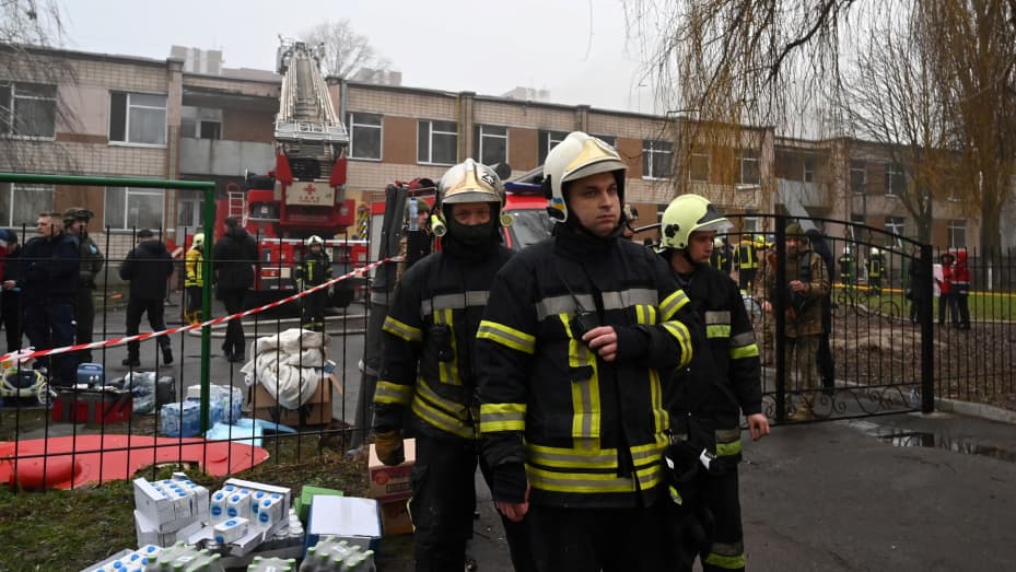 Firefighters work near the site where a helicopter crashed near a kindergarten outside the capital Kyiv, killing 18 people, including two children and Ukrainian interior minister, on January 18, 2023.