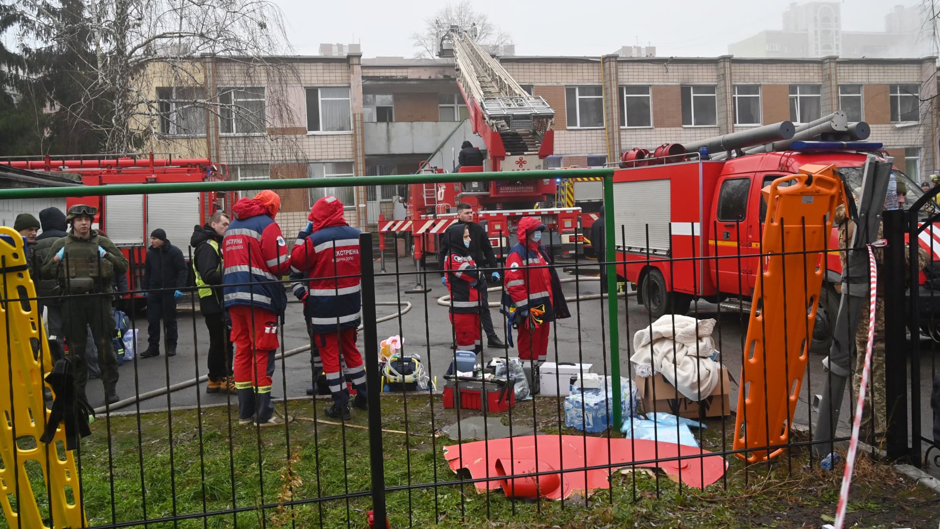 Rescue teams work near the site where a helicopter crashed near a kindergarten outside the capital Kyiv, killing 18 people, including three children and Ukrainian interior minister, on January 18, 2023.