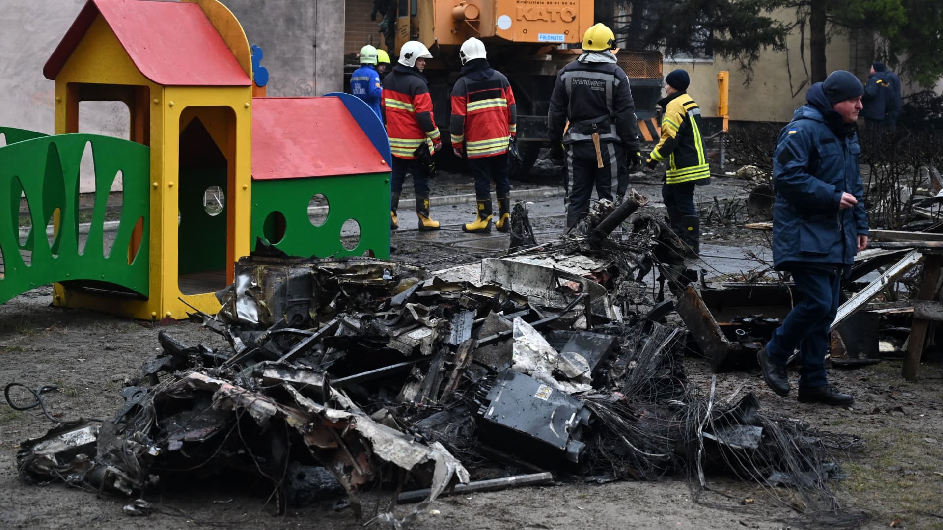 Firefighters work near the site where a helicopter crashed near a kindergarten in Brovary, outside the capital Kyiv.