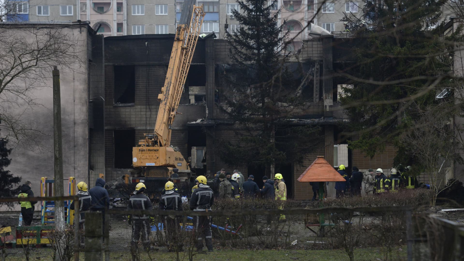 Firefighters work on the site where a helicopter crashed in Brovary in Kyiv.