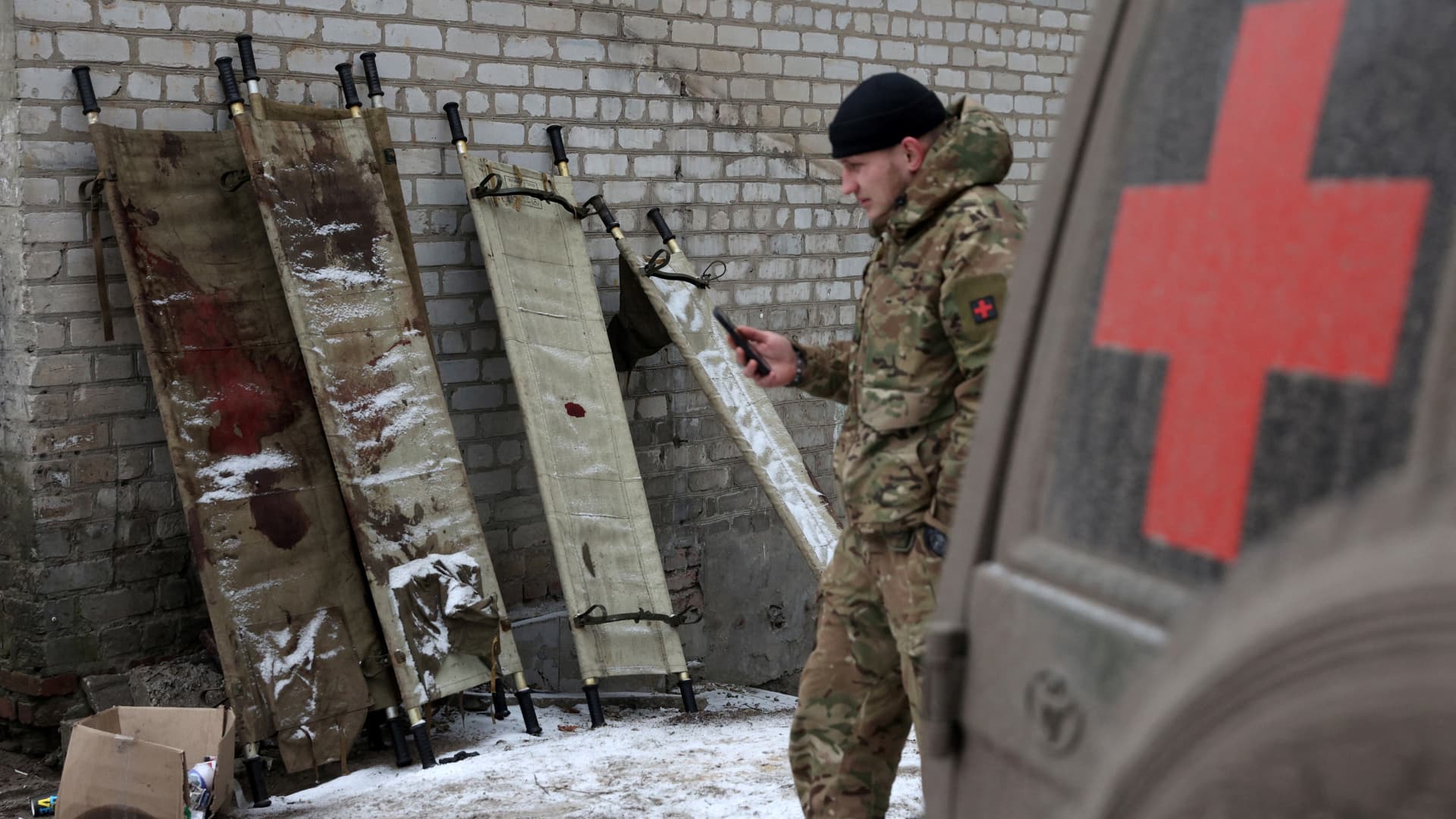 A Ukrainian soldier walks past bloody stretchers outside a stabilisation hospital not far from the front line in Donetsk region on Jan, 15, 2023.