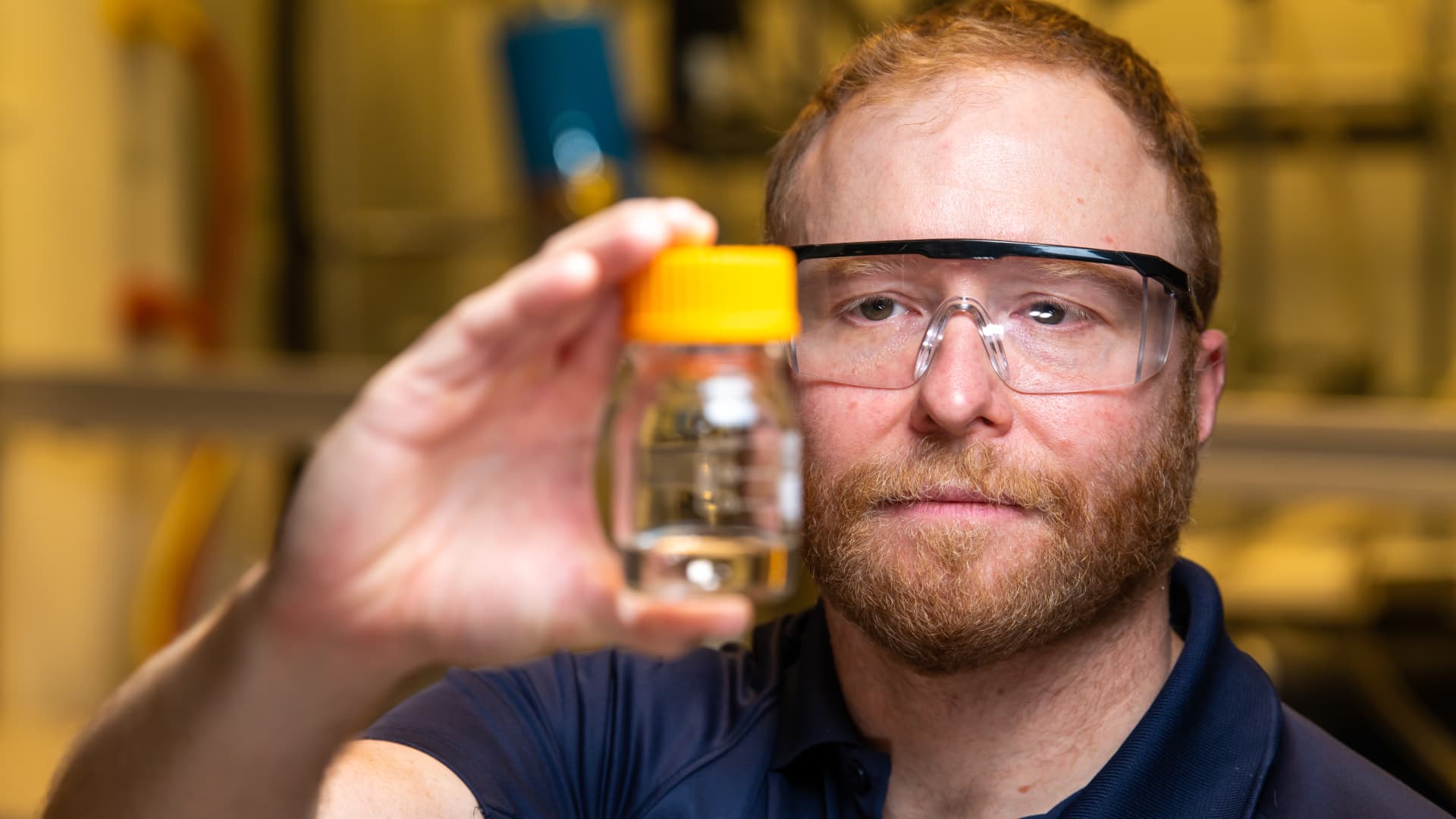 David J. Heldebrant, a chief scientist at PNNL, seen here holding a vial of methanol, made with a process integrated into a point source carbon capture facility. Photo courtesy Andrea Starr at Pacific Northwest National Lab.